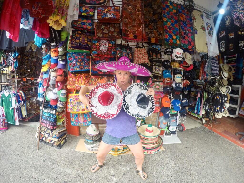 Allison Nevins of TexMex Fun Stuff shopping for sombreros in the Mexican market in Puerto Vallarta.