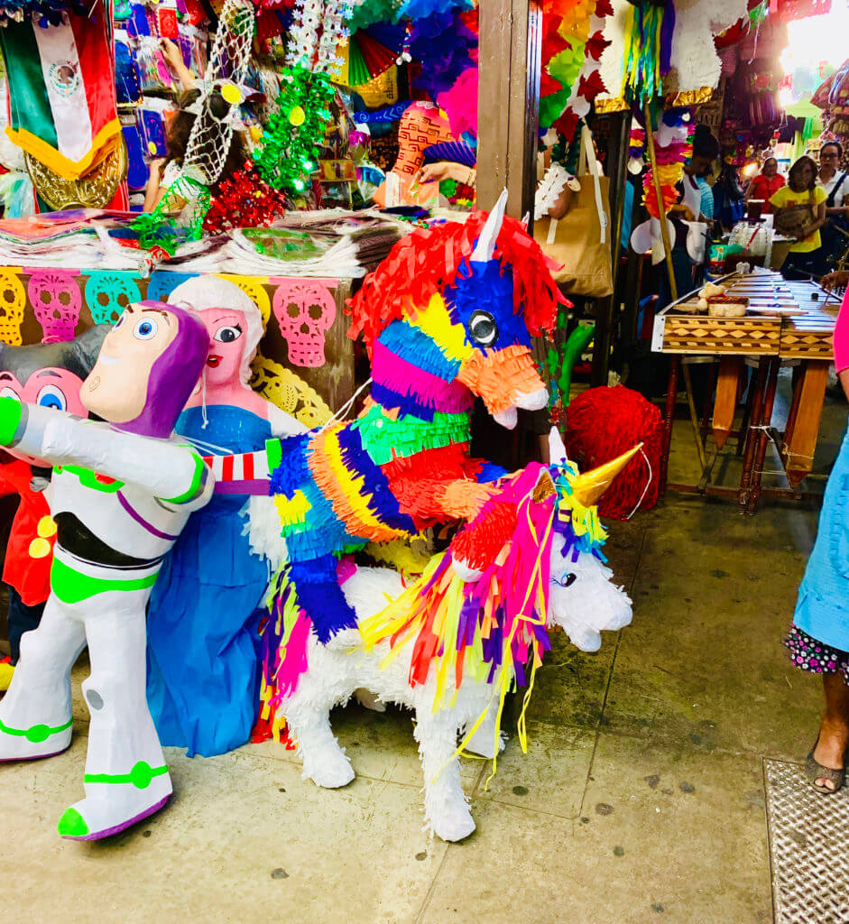 Mexican Mercado Piñatas that are unicorns.